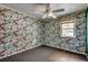 Cozy bedroom with unique floral wallpaper, large window, and neutral carpet at 144 Pink Dogwood Dr., Loris, SC 29569