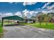 Charming home with well-kept lawn, driveway, and covered parking, surrounded by lush landscaping at 144 Pink Dogwood Dr., Loris, SC 29569