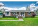 Charming single-story brick home featuring a welcoming front porch and a well-manicured lawn at 144 Pink Dogwood Dr., Loris, SC 29569