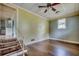 Spacious living room featuring hardwood floors, a ceiling fan, and natural light from the window at 144 Pink Dogwood Dr., Loris, SC 29569