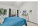 Bright bedroom features a balcony, white dresser and accents, and a comfortable blue comforter at 1525 Lanterns Rest Rd. # 304, Myrtle Beach, SC 29579