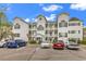 Exterior view of the condo building with parking and landscaped grounds at 1525 Lanterns Rest Rd. # 304, Myrtle Beach, SC 29579