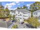 Three-story condominium building featuring classic white facade and ample parking at 1525 Lanterns Rest Rd. # 304, Myrtle Beach, SC 29579