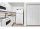 Bright, efficient kitchen with white appliances, cabinets and nearby pantry doors at 1525 Lanterns Rest Rd. # 304, Myrtle Beach, SC 29579