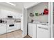 Functional kitchen and laundry area with white appliances and cabinets maximizing space and efficiency at 1525 Lanterns Rest Rd. # 304, Myrtle Beach, SC 29579