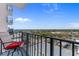 Enjoy city views from this balcony with a chair and black metal railing at 1605 S Ocean Blvd. # 1114, Myrtle Beach, SC 29577