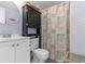 Cozy bathroom with vanity, toilet, cabinet, and beach-themed shower curtain at 1605 S Ocean Blvd. # 1114, Myrtle Beach, SC 29577