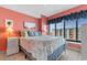 Charming bedroom featuring a bed with seashell-themed bedding, a large window, and coral-colored walls at 1605 S Ocean Blvd. # 1114, Myrtle Beach, SC 29577