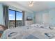 Inviting bedroom features two beds, balcony access with ocean views, and light blue walls at 1605 S Ocean Blvd. # 1114, Myrtle Beach, SC 29577