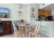 Bright dining area with a glass table, seating for four, and an open view to the patio at 1605 S Ocean Blvd. # 1114, Myrtle Beach, SC 29577