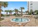 Inviting outdoor hot tubs surrounded by lush palm trees, benches and paver stones at oceanfront condo complex at 1605 S Ocean Blvd. # 1114, Myrtle Beach, SC 29577