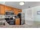 Well-lit kitchen features oak cabinets, tile floors, and stainless steel appliances at 1605 S Ocean Blvd. # 1114, Myrtle Beach, SC 29577