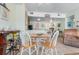 Bright living room featuring a dining area, kitchen, and comfortable seating with tan tile flooring throughout at 1605 S Ocean Blvd. # 1114, Myrtle Beach, SC 29577
