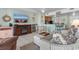 Cozy living room features tile flooring, a flat-screen TV, and a view to the kitchen with barstool seating at 1605 S Ocean Blvd. # 1114, Myrtle Beach, SC 29577