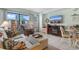 Bright living room featuring tile flooring, and a flat-screen TV. Windows offer lovely views at 1605 S Ocean Blvd. # 1114, Myrtle Beach, SC 29577