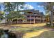 Lovely exterior view of unit #203 with spacious screened porches overlooking a grassy lawn at 180 Rothbury Circle # 203, Myrtle Beach, SC 29572