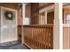 Inviting front porch featuring white door with lavender wreath, unit number, and wood railing at 180 Rothbury Circle # 203, Myrtle Beach, SC 29572