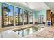 Indoor jacuzzi with three windows with an outdoor view, plus easy access via stairs and handrail at 180 Rothbury Circle # 203, Myrtle Beach, SC 29572