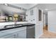 Kitchen area showcasing granite counters, stainless dishwasher, and a pass-through to the living area at 180 Rothbury Circle # 203, Myrtle Beach, SC 29572