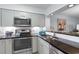 Bright kitchen with stainless steel appliances, granite countertops, and white subway tile backsplash at 180 Rothbury Circle # 203, Myrtle Beach, SC 29572