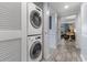 Hallway with stacked washer and dryer and views into the living room area at 180 Rothbury Circle # 203, Myrtle Beach, SC 29572
