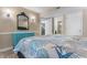 Stylish main bedroom with an accent cabinet and views into the main bathroom and living area at 180 Rothbury Circle # 203, Myrtle Beach, SC 29572