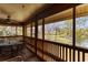 Screened-in porch with seating area overlooking a lush, wooded view and a pond at 180 Rothbury Circle # 203, Myrtle Beach, SC 29572