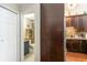 Hallway view into a blue bathroom featuring a shelf and walk-in shower at 1860 Auburn Ln. # 19E, Surfside Beach, SC 29575