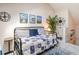 Cozy bedroom with a nautical theme, featuring beach-inspired artwork and a decorative compass at 1860 Auburn Ln. # 19E, Surfside Beach, SC 29575