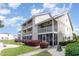 Inviting condo building featuring multiple balconies, screened porches, and manicured greenery at 1860 Auburn Ln. # 19E, Surfside Beach, SC 29575