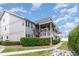 Condo exterior featuring a covered porch, lush landscaping, and a sidewalk leading to the entrance at 1860 Auburn Ln. # 19E, Surfside Beach, SC 29575