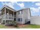 Multi-story condo building with decks and outdoor living space, enhanced by mature landscaping at 1860 Auburn Ln. # 19E, Surfside Beach, SC 29575