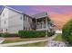 Condo exterior featuring a covered porch, lush landscaping, and a sidewalk leading to the entrance at 1860 Auburn Ln. # 19E, Surfside Beach, SC 29575