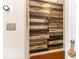 Hallway featuring decorative wall paneling, a nautical rope doorstop, and wood floors at 1860 Auburn Ln. # 19E, Surfside Beach, SC 29575