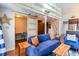 Stylish living room featuring a blue sofa, wood accents, and a view of a small office and staircase at 1860 Auburn Ln. # 19E, Surfside Beach, SC 29575