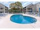 Community pool area with lounge chairs, surrounded by well-maintained landscaping at 1860 Auburn Ln. # 19E, Surfside Beach, SC 29575