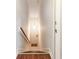 Staircase leading from the wood floor to the tiled entrance with a hanging light fixture at 1860 Auburn Ln. # 19E, Surfside Beach, SC 29575