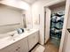 Bright bathroom with double sink vanity, a large mirror, and shower with a fun fish-themed curtain at 187 S Reindeer Rd., Surfside Beach, SC 29575