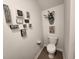 Cozy half bathroom featuring decorative wall art, toilet, and wood flooring at 187 S Reindeer Rd., Surfside Beach, SC 29575