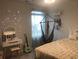Bedroom with hanging chair, vanity, and guitar at 187 S Reindeer Rd., Surfside Beach, SC 29575