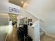 Bright hallway with a piano, staircase and decorative wall hangings at 187 S Reindeer Rd., Surfside Beach, SC 29575
