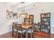 Dining room with a wooden table, six chairs, hardwood floors, and a chandelier at 189 Ella Kinley Circle # 203, Myrtle Beach, SC 29588