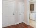 Entryway with hardwood floors, a white front door, closet door, and laundry room at 189 Ella Kinley Circle # 203, Myrtle Beach, SC 29588