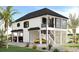 Stunning raised beach home with a modern design and lush landscaping at 196 Brown Pelican Loop, Pawleys Island, SC 29585