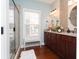 Bright bathroom featuring a tiled shower, wood cabinets with granite countertops, and decorative fixtures for a luxurious feel at 1965 24Th Ave. N, North Myrtle Beach, SC 29582