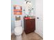 Cozy powder room featuring a toilet, small vanity, and decorative coastal artwork at 1965 24Th Ave. N, North Myrtle Beach, SC 29582