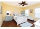 Bright bedroom with yellow walls, wood floors, ceiling fan, and coastal-themed decorations at 1965 24Th Ave. N, North Myrtle Beach, SC 29582