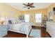 Bright bedroom with yellow walls, wood floors, ceiling fan, and coastal-themed decorations at 1965 24Th Ave. N, North Myrtle Beach, SC 29582