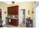 Kitchen featuring wooden cabinets, granite countertops, and a stainless steel mini fridge at 1965 24Th Ave. N, North Myrtle Beach, SC 29582