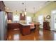 Well-lit kitchen featuring an island with granite countertops, wood cabinets, and a dining area with seating for four at 1965 24Th Ave. N, North Myrtle Beach, SC 29582
